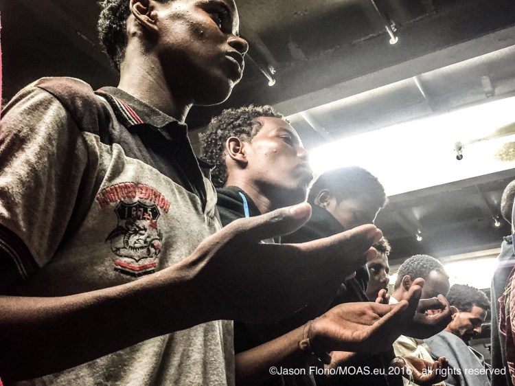 ERITREAN PRAYERS ON BOARD RESCUE BOAT © JASON FLORIO/MOAS.EU