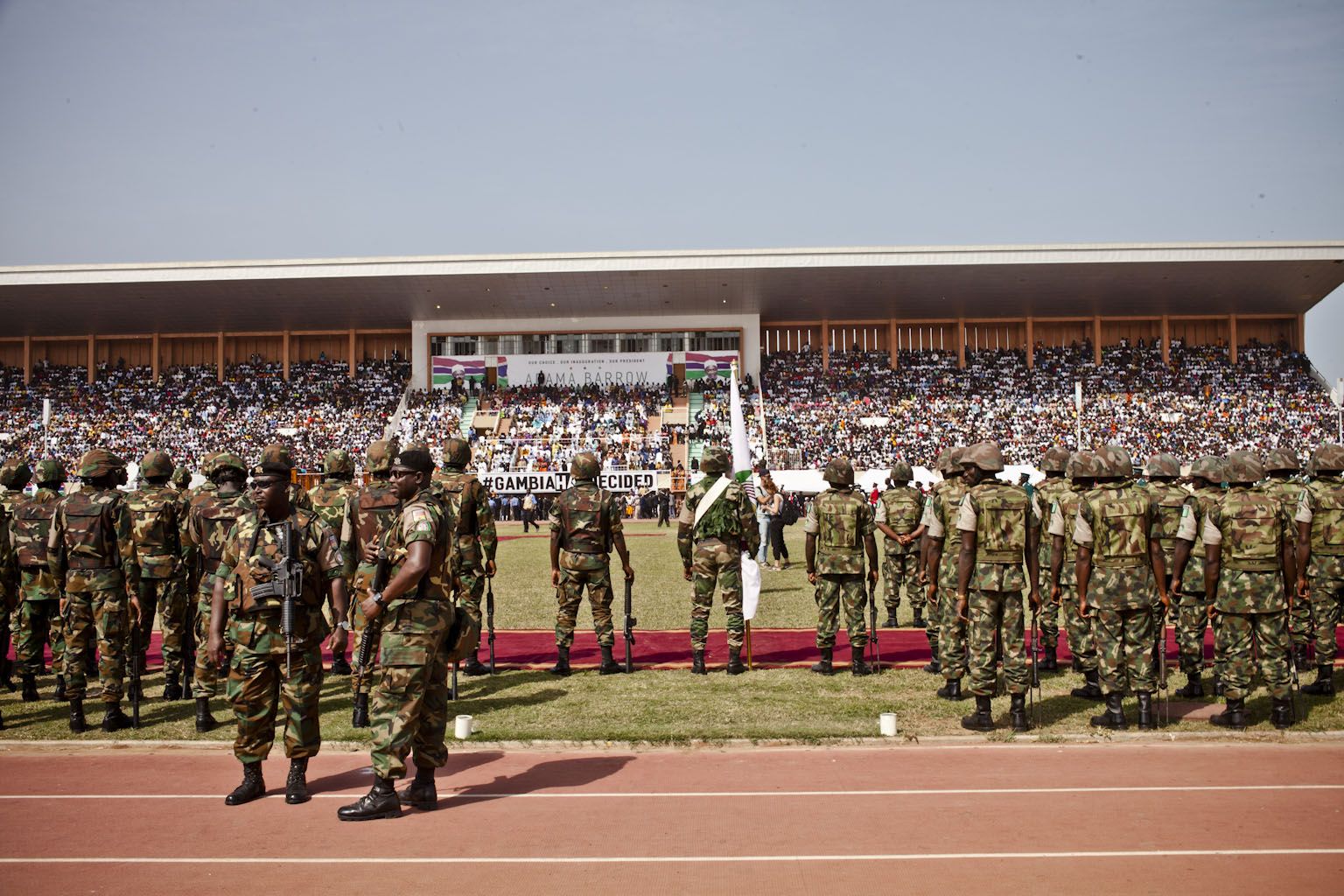 Gambian troops stand to attention, as they wait for the arrival of President Adama Barrow, Bakau Stadium © Helen Jones-Florio