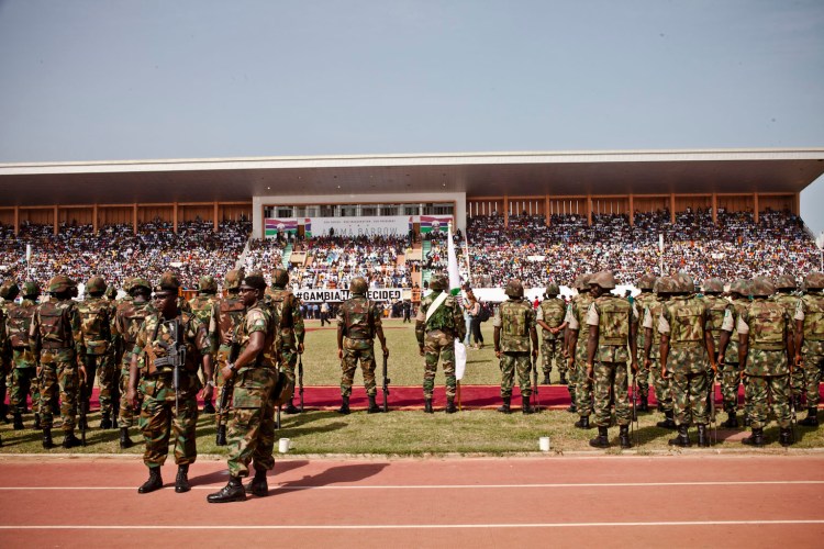 Gambian troops stand to attention, as they wait for the arrival of President Adama Barrow, Bakau Stadium © Helen Jones-Florio