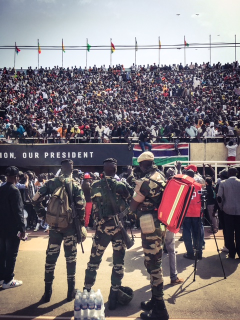 ECOWAS troops photograph the crowds, with their phones at Bakau Stadium © Helen Jones-Florio