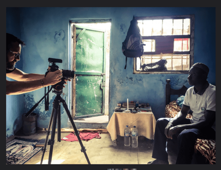 Photojournalist, Jason Florio, prepares to interview ex-Mile2 prisoner, Ballo, The Gambia, West Africa