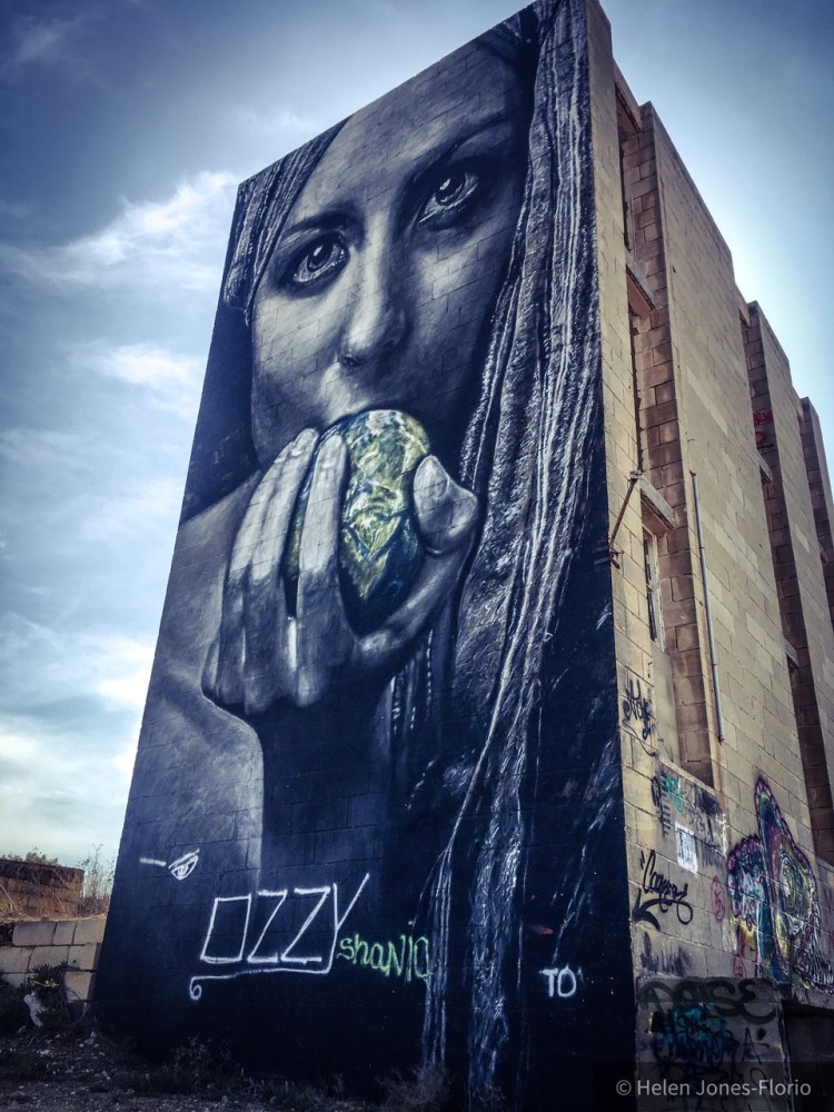  Graffiti mural, Malta - girl eats apple of the world ©Helen Jones-Florio