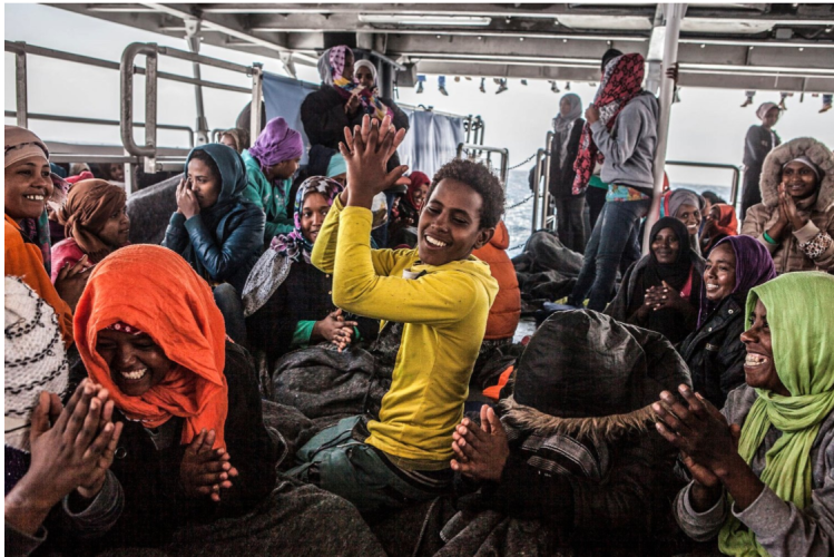 Unaccompanied minor, Eritrean, Henock, onboard rescue ship, leads refugees in song of thanks ©Jason Florio