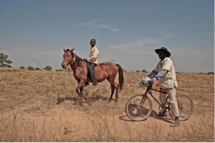 Image: ©Jason Florio-2009 Gambian boy on his horse & farmer, on his bicycle, near the town of Basse, The Gambia, West Africa