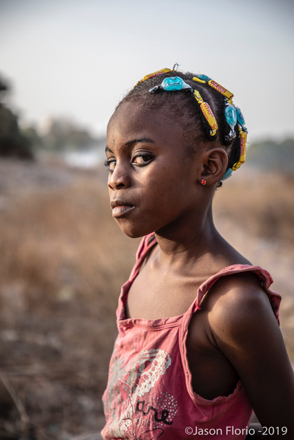 'Minti head' portrait of young Gambian girl - decorates her hair with candy, the Gambia, West Africa © Jason Florio