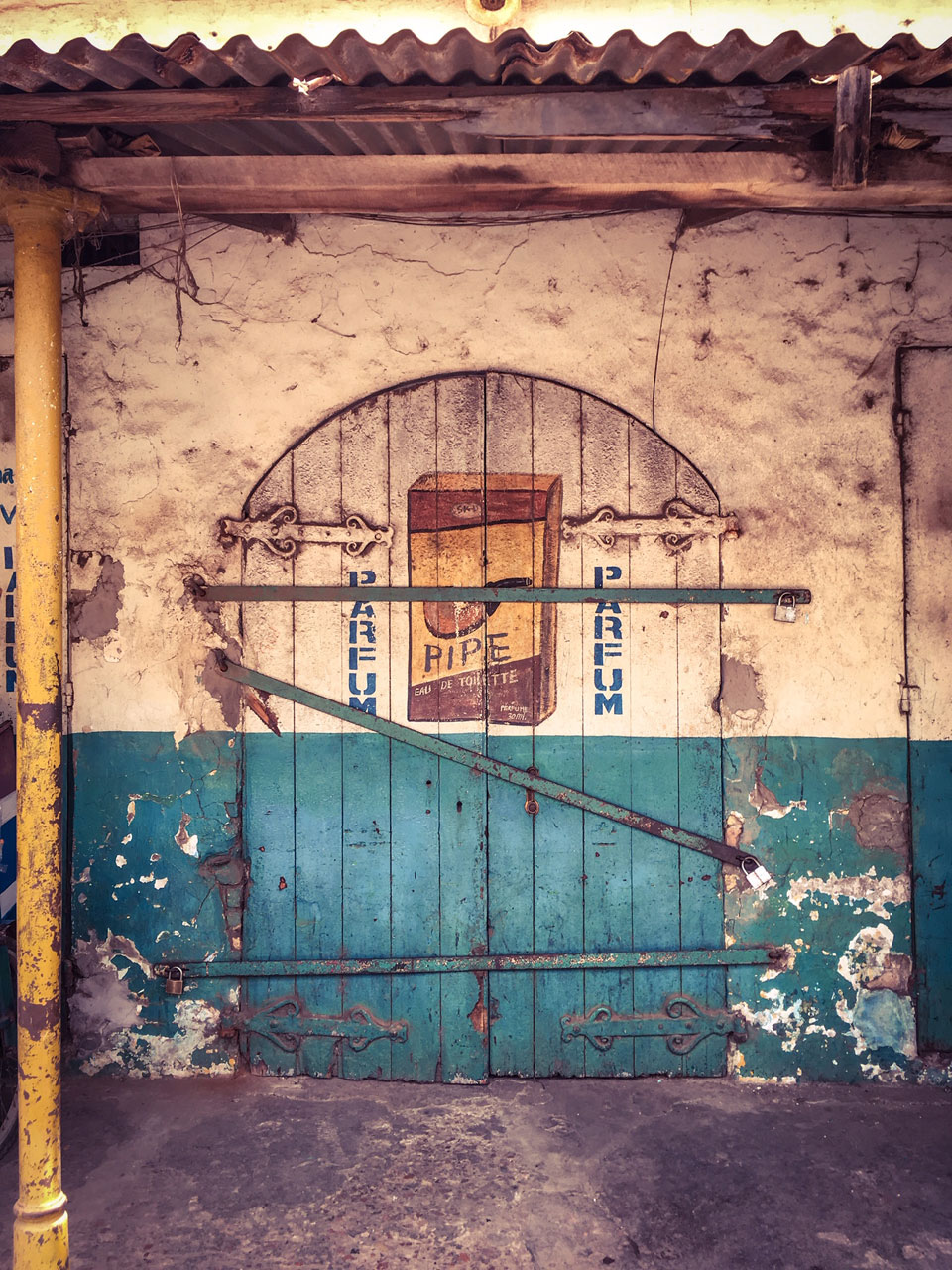 Gambia Doors - 'Pipe' eau de toilette, decaying storefront, Banjul, the Gambia ©Helen Jones-Florio