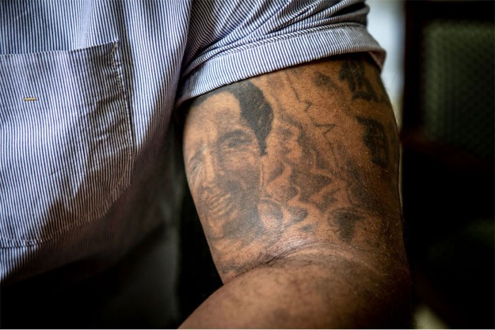 Baba Hydara with the tattoo of his murdered father, Gambia newspaper editor, and journalist, Deyda Hydara, on his arm © Jason Florio 