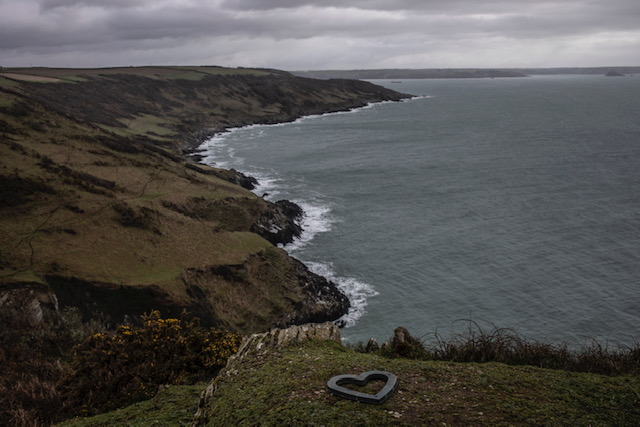 (self) Isolation - image © Jason Florio - a lone stone-shaped heart, on a clifftop, overlooking the sea, Cornwall, UK