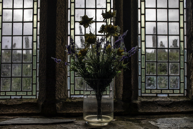 (self) Isolation - image © Jason Florio - a vase of flowers on the window ledge in an ancient country church, Cornwall, UK