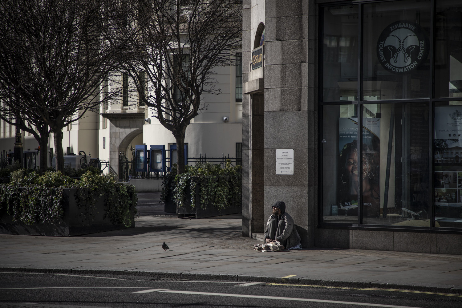 COVID 19 London lockdown. Homelessness - a lone homeless man sits on the street, Central London. Image © Jason Florio