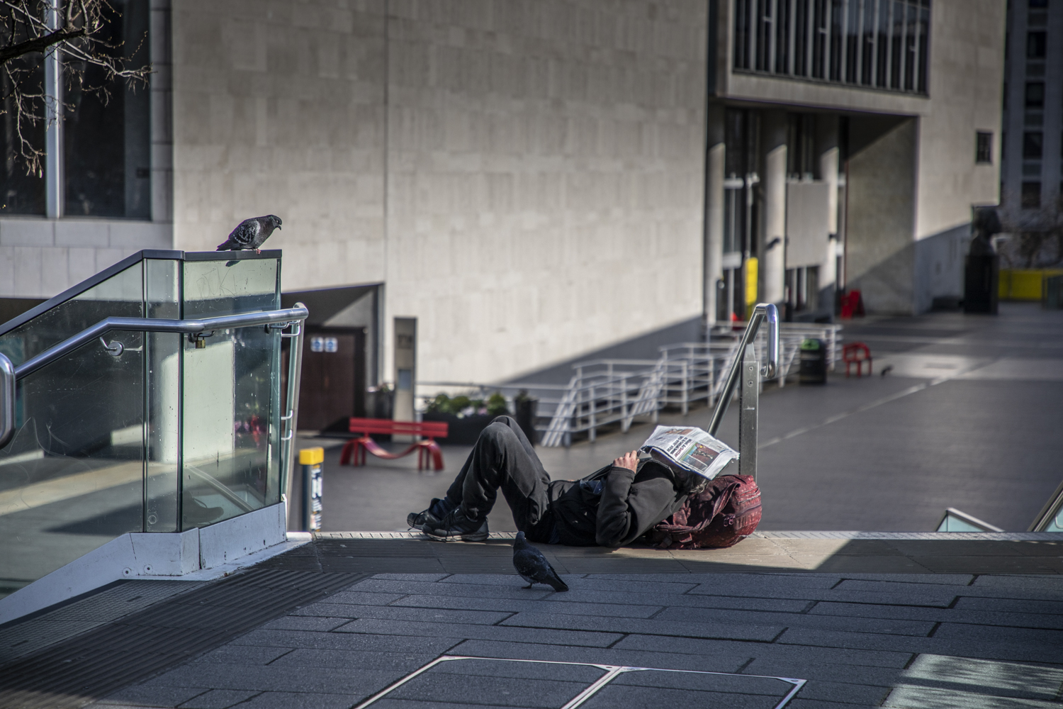 COVID 19 London lockdown. Homelessness - a homeless man lies sleelping on the floor at the Southbank. Image ©Jason Florio