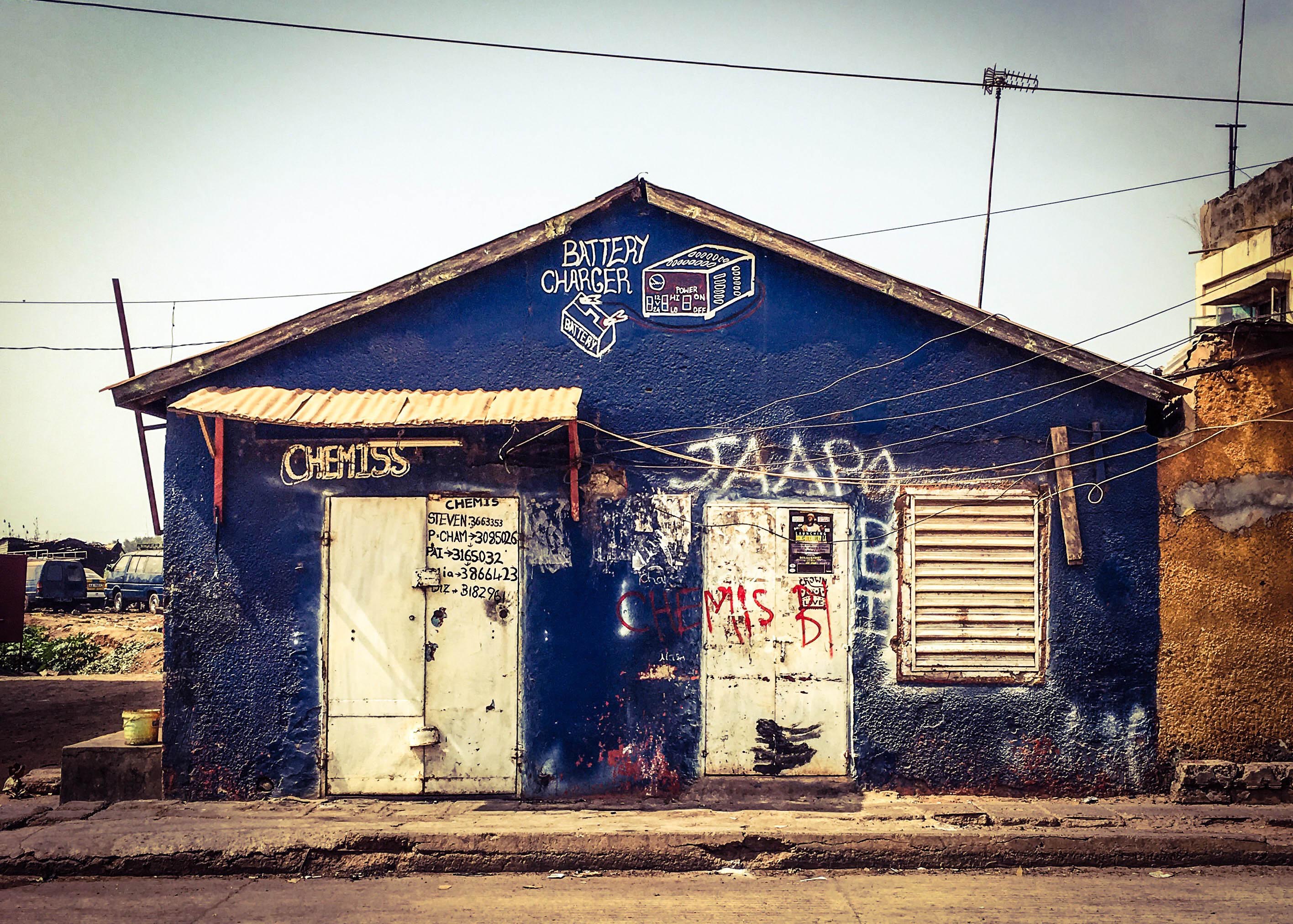 #GambiaDoors: Doors and Storefronts of The Gambia, West Africa. Double-fronted shopfront in Banjul, the capital city of Gambia. Image © Helen Jones-Florio