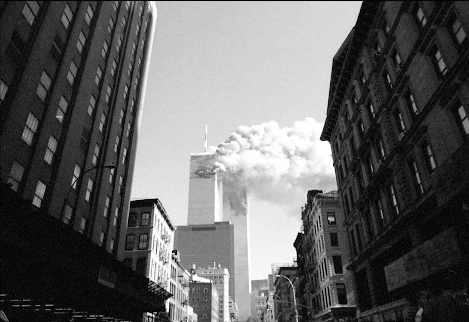 'The Day The Towers Fell - my 9/11 journey' Jason Florio: September 11th, 2001-the North Tower on fire after the first plane hits, World Trade Center Towers, NYC. Black and white image ©Jason Florio