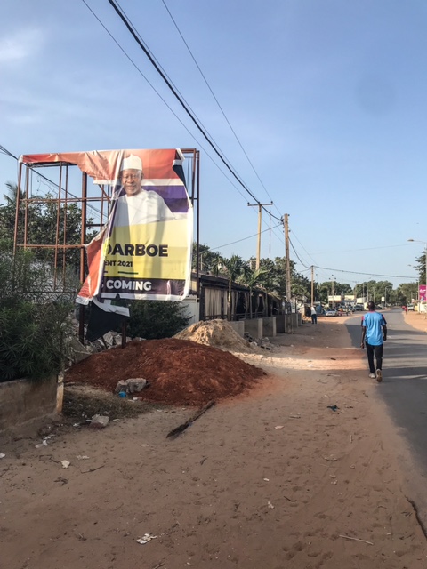 Gambia Elections 2021 - a destroyed UDP/Oussainou Darboe billboard, Bakau street. Image © Helen Jones-Florio