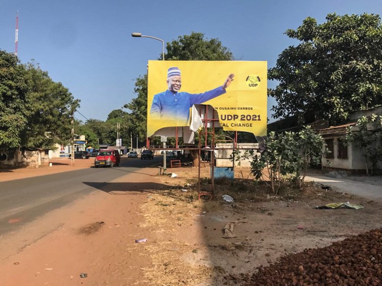 GAMBIA ELECTIONS 2021: A BILLBOARD DEPICTING OPPOSITION LEADER, OUSSAINOU DARBOE, PARTIALLY DESTROYED BY ANTI-UDP SUPPORTERS, GAMBIA. IMAGE ©HELEN JONES-FLORIO