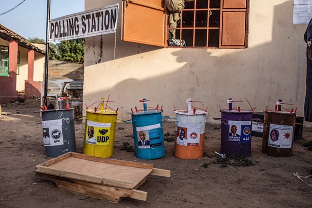 Gambia Elections 2021 -voting barrels, containing voting marbles, counted and re-sealed and polling station. Image © Jason Florio
