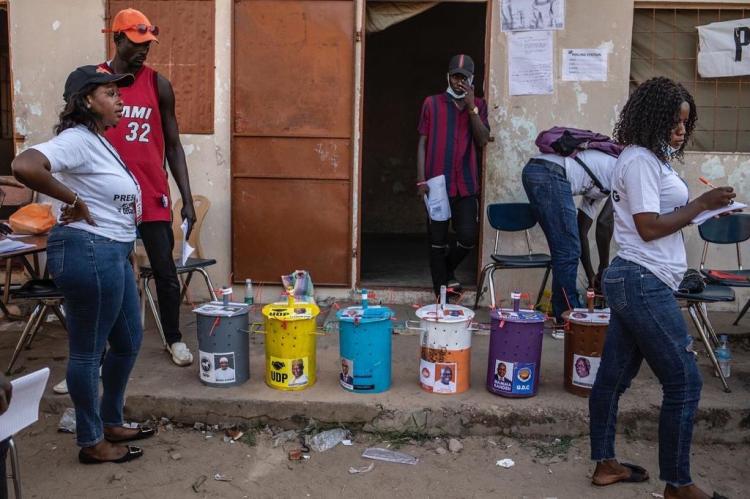 Gambia Elections 2021 -voting barrels, containing voting marbles, counted and re-sealed and polling station. Image © Jason Florio