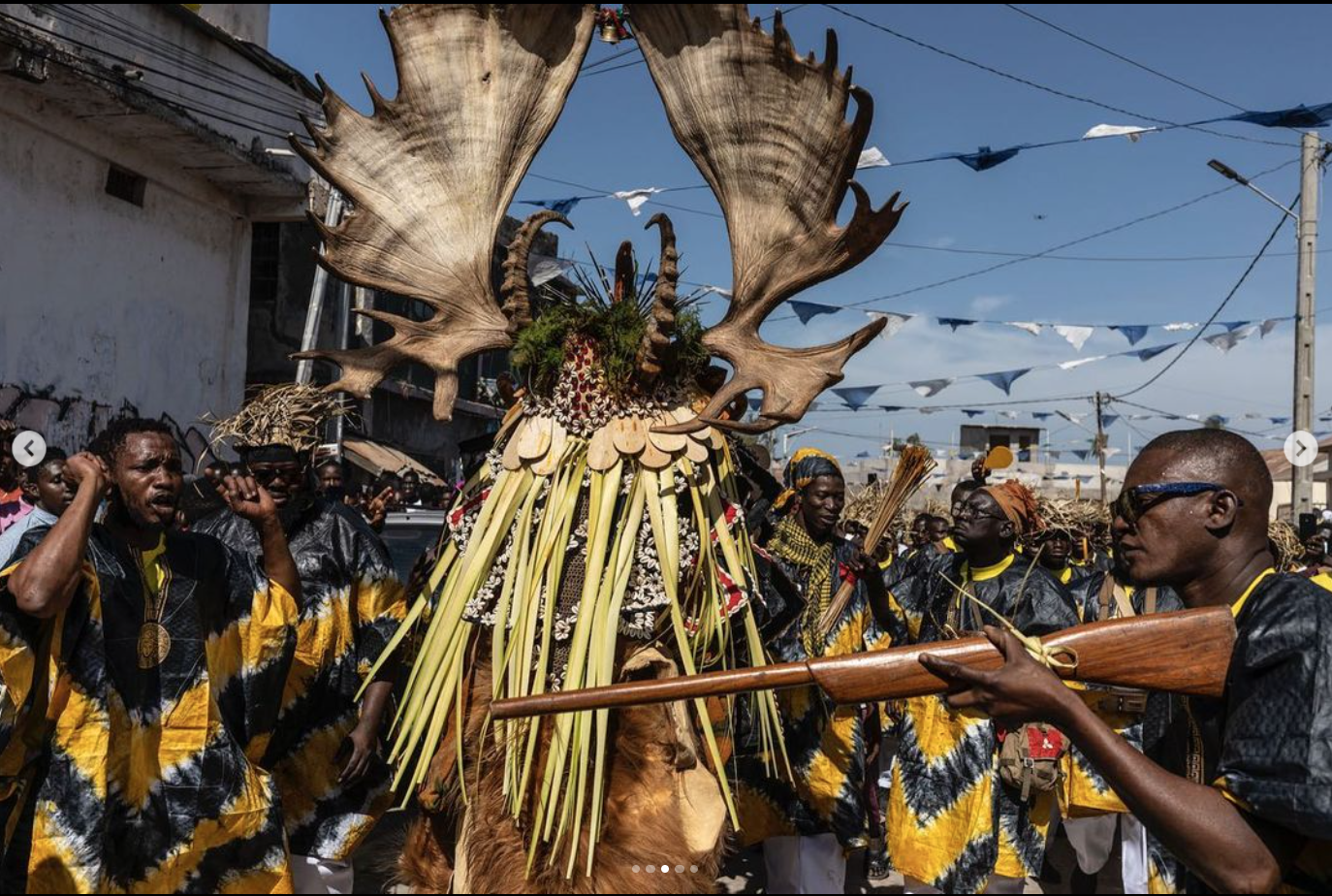 Happy New Year! Traditional Masquerades Parade, The Gambia, West Africa - 'The Hunting Society' parades in the streets of the capital,Banjul, protected by his society members. Image © Jason Florio