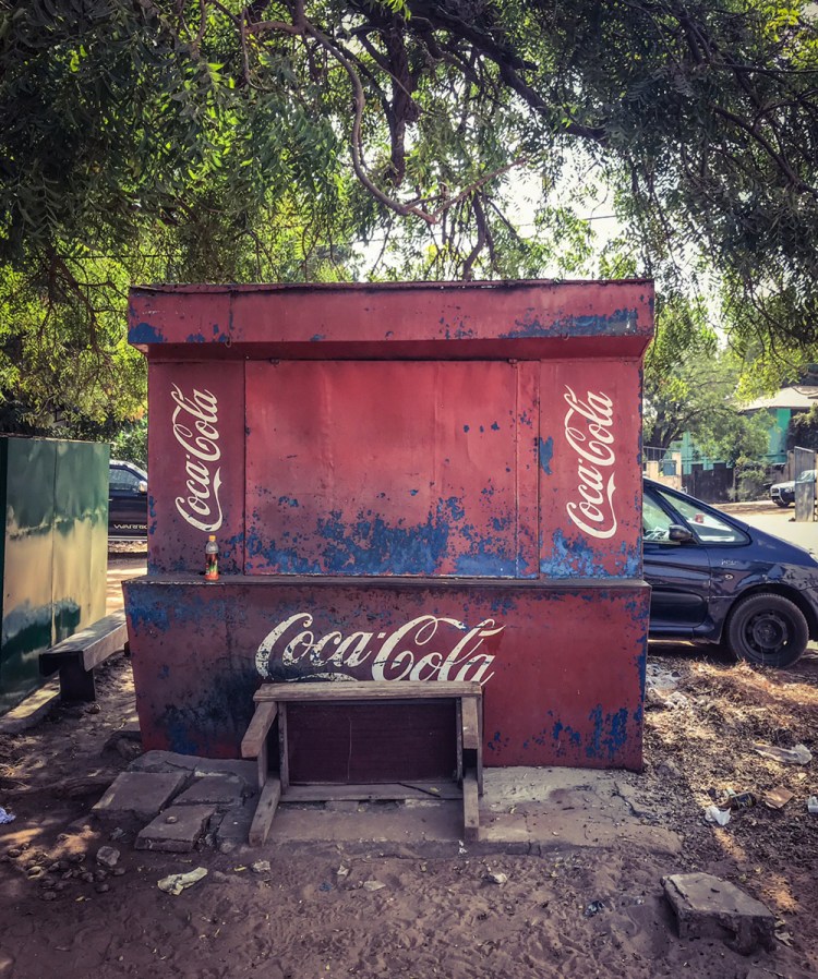 #GambiaDoors - the (un)mundane doors and storefronts of The Gambia, West Africa. A small local stall, advertising Coca Cola, Banjul. Image ©Helen Jones-Florio
