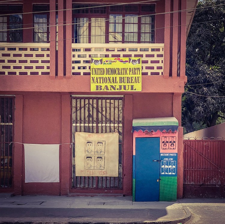 #GambiaDoors - the (un)mundane doors and storefronts of The Gambia, West Africa. A passport booth, Banjul. Image ©Helen Jones-Florio