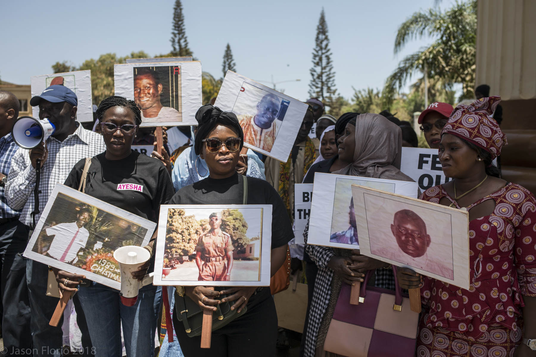 The Gambia: Government White Paper is out-victims of ex-president, Yahya Jammeh, gather for a peaceful protest, holding banners with photos of family members killed under Jammeh's regime. Image © Jason Florio