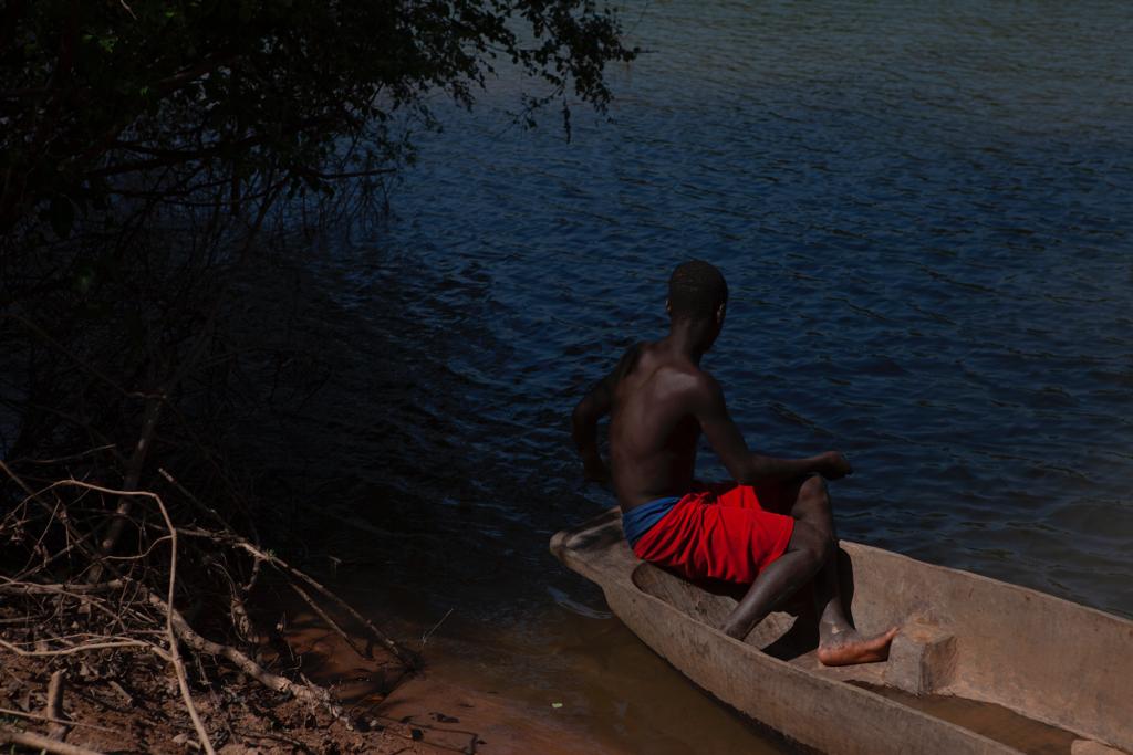 River Gambia - image of a sitting in his canoe on the shores of the river, Senegal, West Africa. Image ©Jason Florio